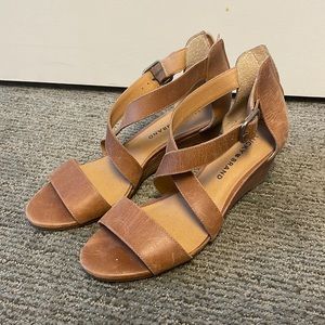 Lightly worn Wedge heels. slight scratching on the shoes due to the material.